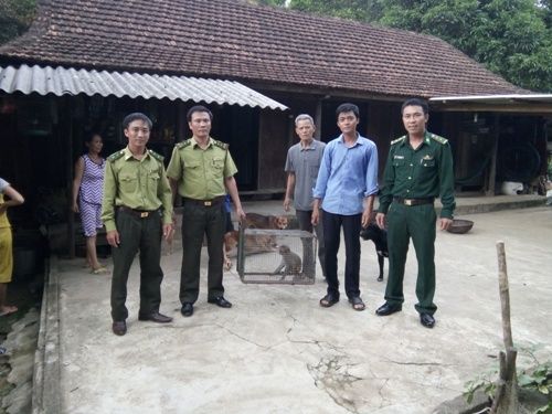 A group of people standing in front of a building
Description automatically generated