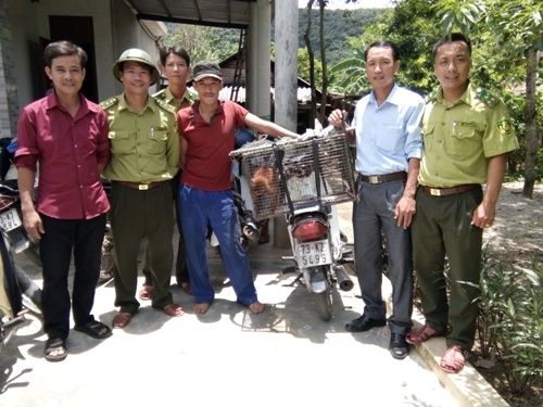 A group of men standing outside a building
Description automatically generated