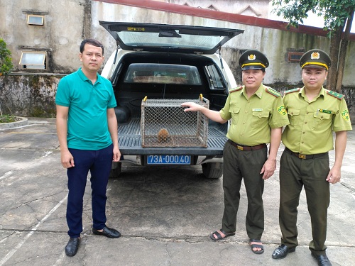 A group of men standing next to a car
Description automatically generated