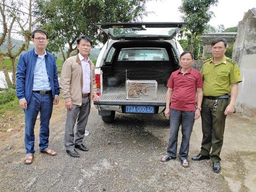 A group of men standing next to a truck
Description automatically generated