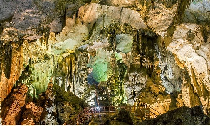 A cave with a staircase and stalactites Description automatically generated