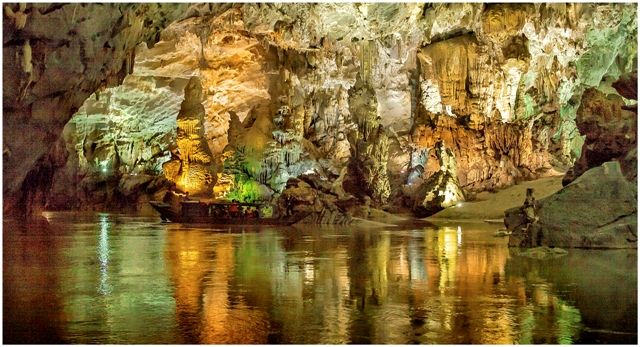 A cave with a body of water Description automatically generated