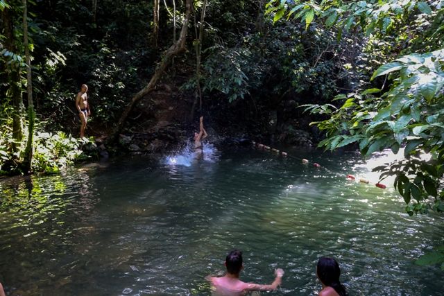 A group of people in a river Description automatically generated