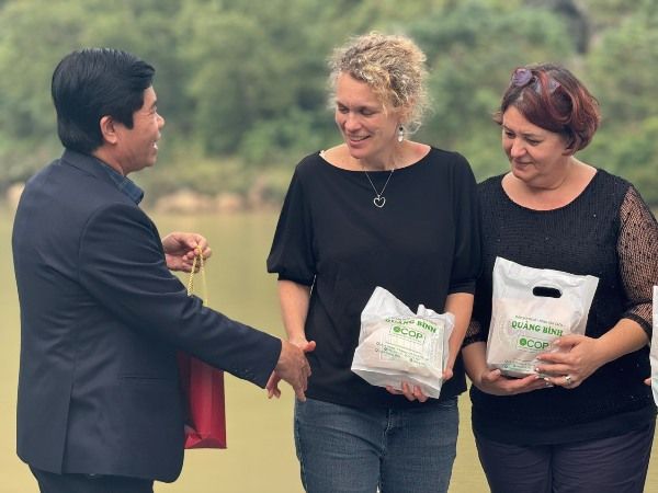 A group of people holding plastic bags Description automatically generated