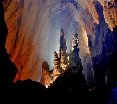 A cave with a light shining through Description automatically generated with medium confidence