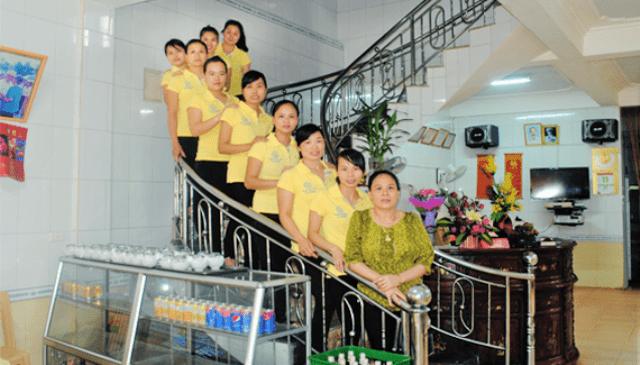 A group of women posing on a staircase Description automatically generated